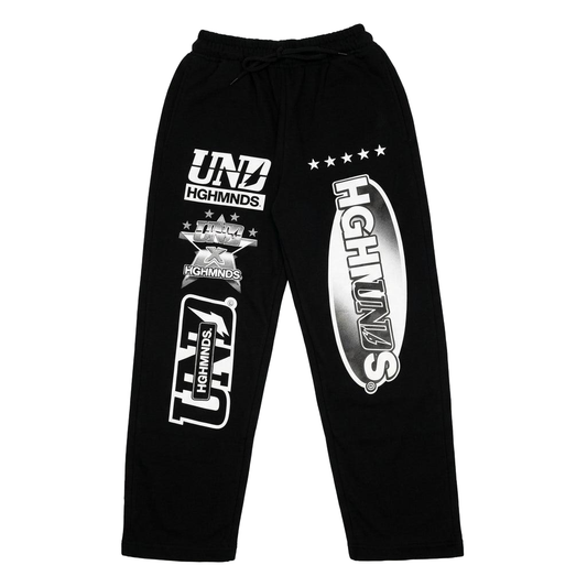 Black minimalist street-style joggers with various white graphic prints including "UND," "HGHMNDS," and stars, reflecting Suray's aesthetic.